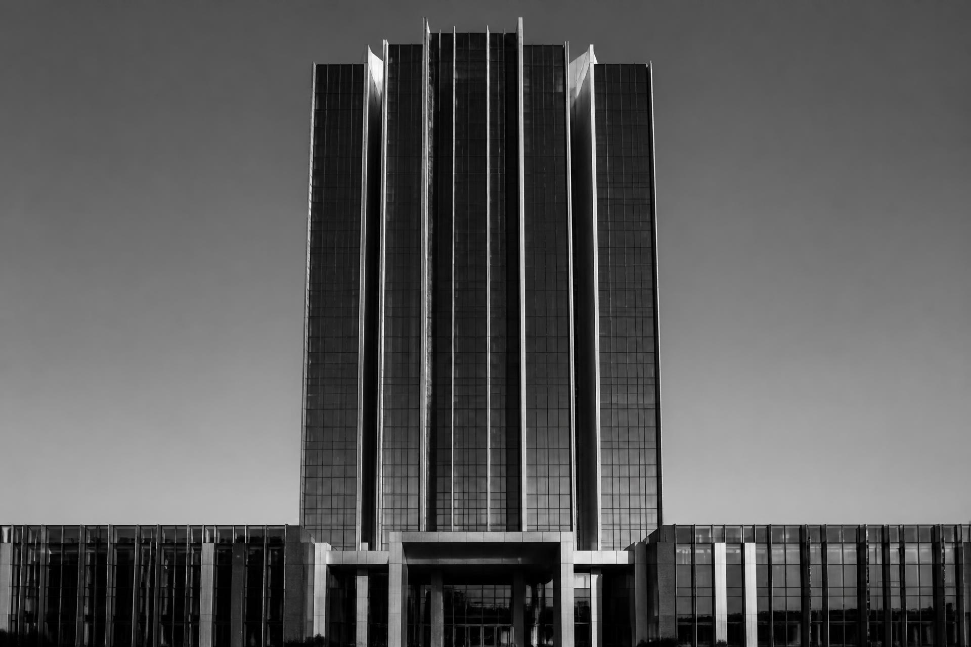 Black-and-white photograph of a modern corporate office tower